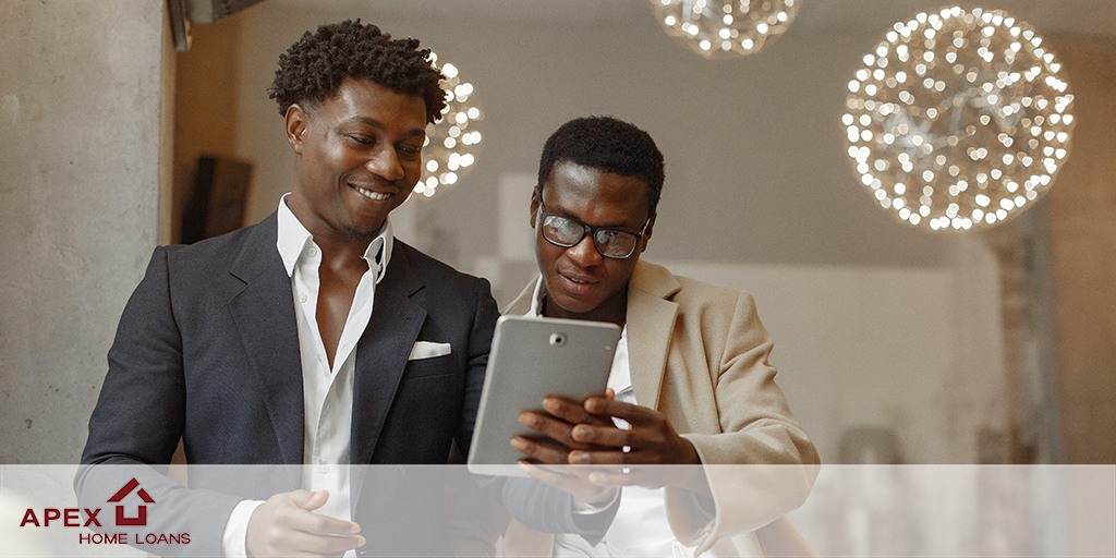 Gay couple reviewing properties on a tablet device
